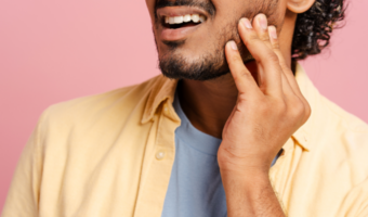 Man holding his jaw in pain.