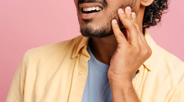 Man holding his jaw in pain.