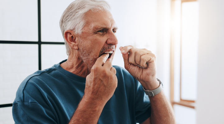 Person flossing their teeth.