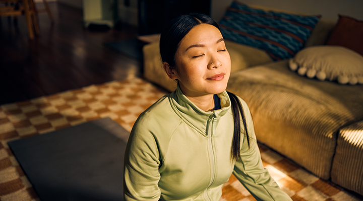 Women sitting in the sun and doing yoga.