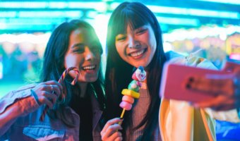 Two people smiling and taking a selfie.