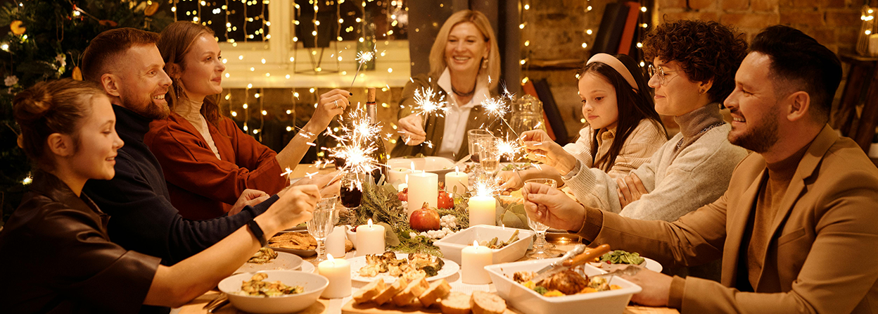 Family sitting around the dinner table during the holidays.