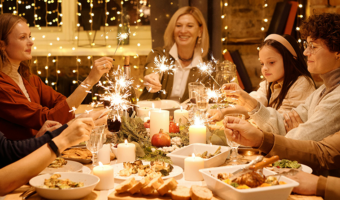 Family sitting around the dinner table during the holidays.