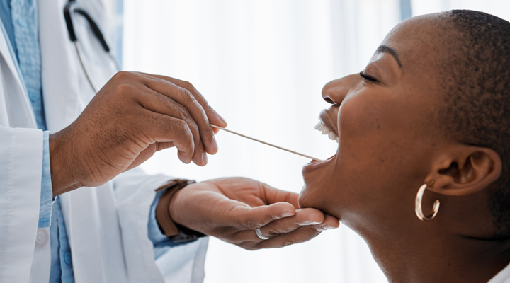 Person getting checked for oral cancer by a dentist.