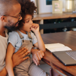 Father and son talking to their dentist on the computer.