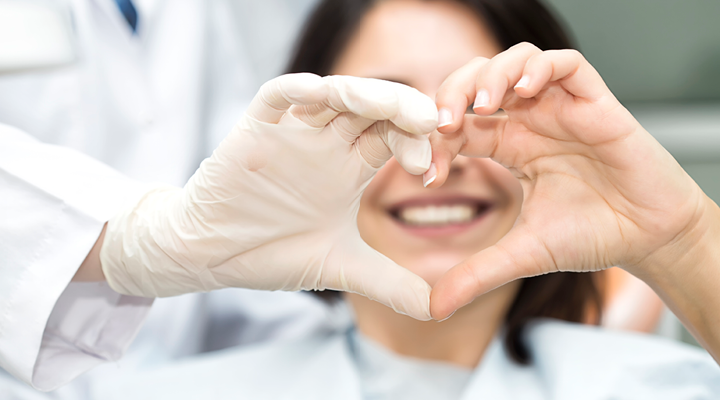 Person holding up a heart with their hands.