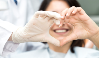 Person holding up a heart with their hands.