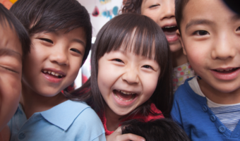 Children laughing and smiling together.