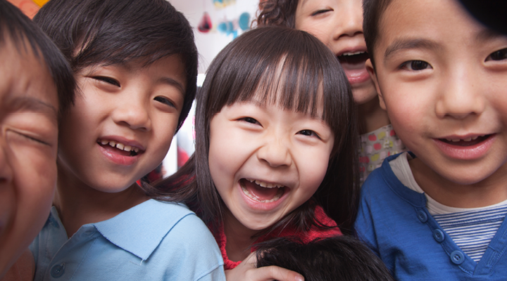 Children laughing and smiling together.