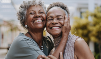 Two people smiling and laughing together.