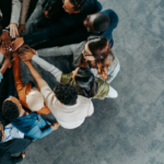 Coworkers in a group huddle.