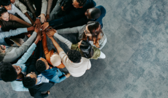 Coworkers in a group huddle.