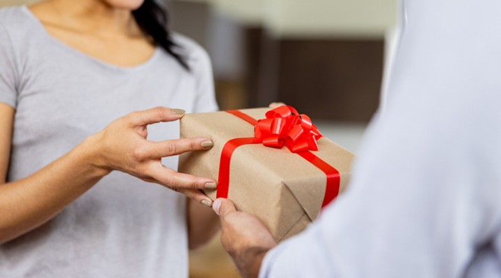 Person giving a gift to their dentist.