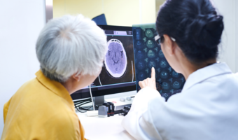 Doctor showing a patient a scan of their brain.