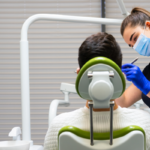 Dental assistant working on a patient in the dental chair.