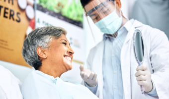 Dentist giving an exam to an older dental patient.