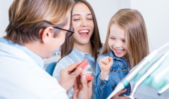 Family laughing and smiling at the dentist.